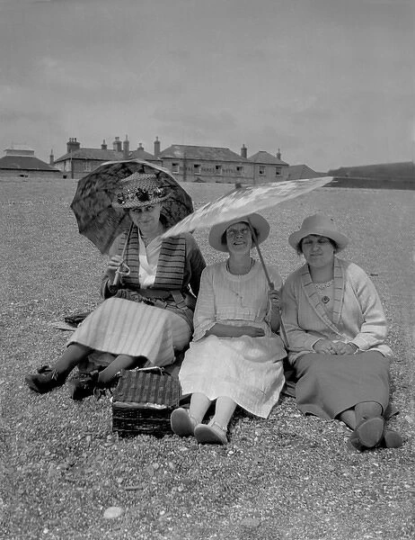 Three women with parasols