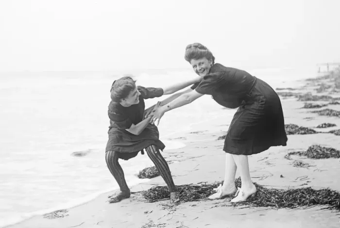Framed Print : Two women in period bathing costumes on the beach in America Framed Print : Two women in period bathing costumes on the beach in America