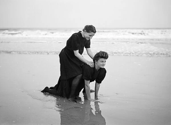 Two women in period bathing costumes on the beach - Atlantic