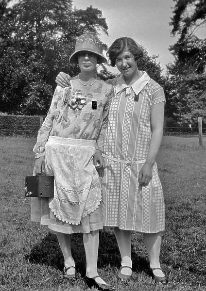 Two women posing in a field