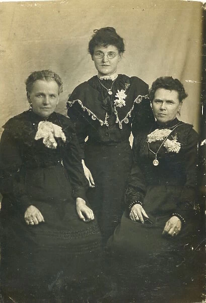 Three women, probably from the same family, all in black, possibly in mourning