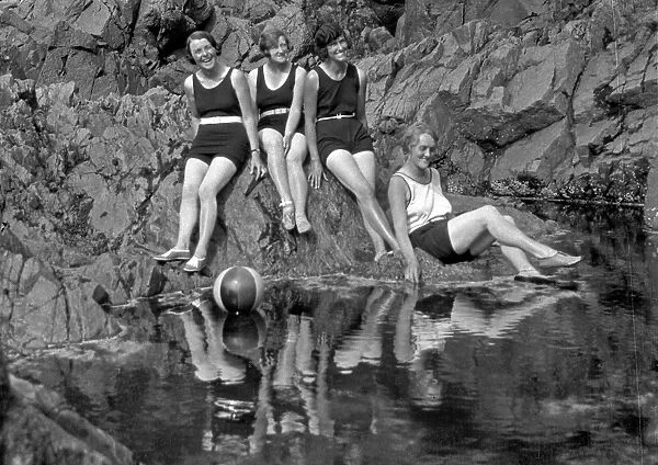 Four women in swimsuits