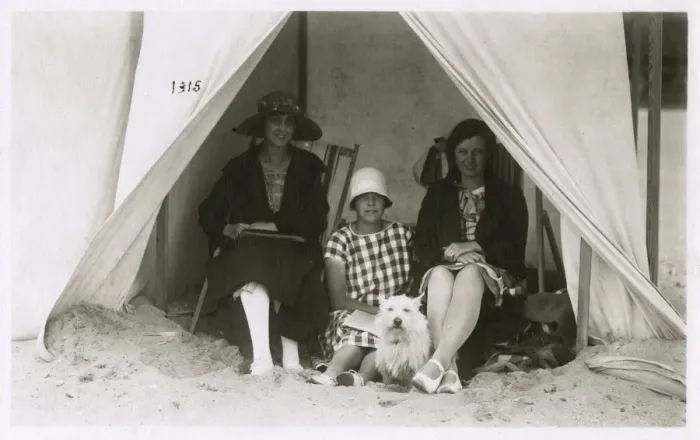 Framed Print : Three women in a tent on a beach with a white terrier Framed Print : Three women in a tent on a beach with a white terrier