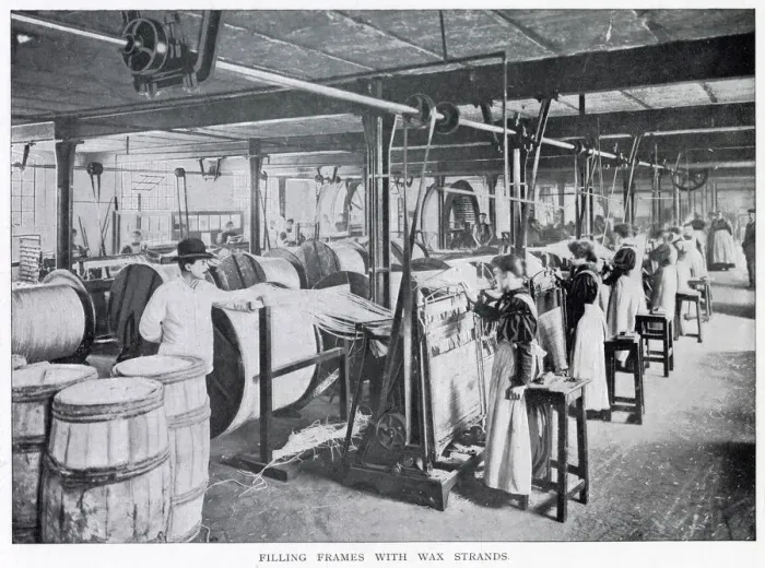 Framed Print : Women working in a large factory making wax candles with a foreman standing watching them Framed Print : Women working in a large factory making wax candles with a foreman standing watching them