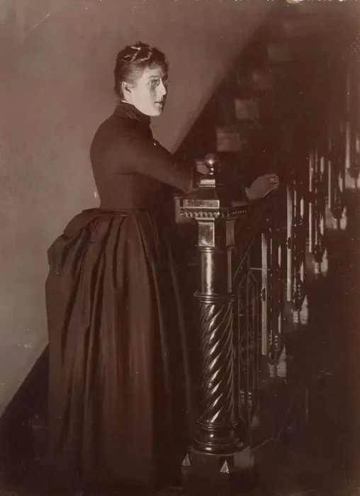 Framed Print : Woolfe family of The Clough, Hale, Bucklow, Cheshire - possibly Lucy, at the foot of a staircase in her home, The Clough. (2 of 2) Date: 1889 Framed Print : Woolfe family of The Clough, Hale, Bucklow, Cheshire - possibly Lucy, at the foot of a staircase in her home, The Clough. (2 of 2) Date: 1889