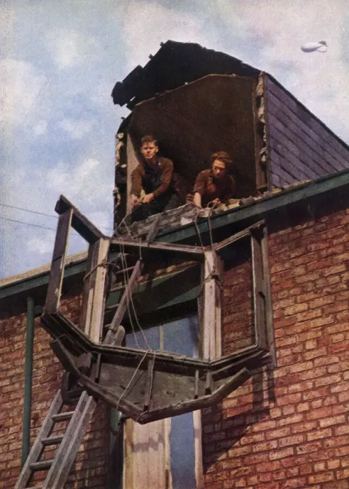 Framed Print : Two workers lowering a window pane Framed Print : Two workers lowering a window pane