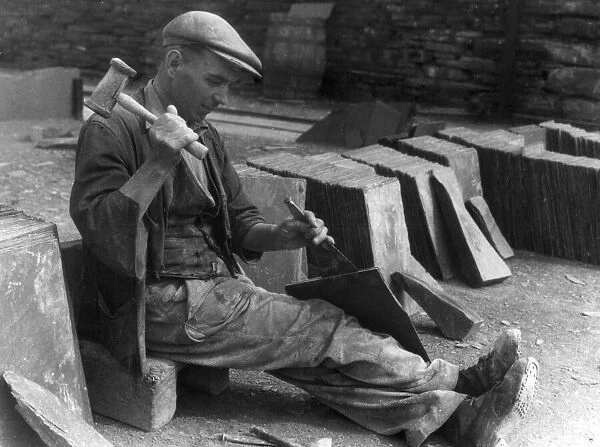 A workman splitting slates in one of the biggest slate quarries in the world