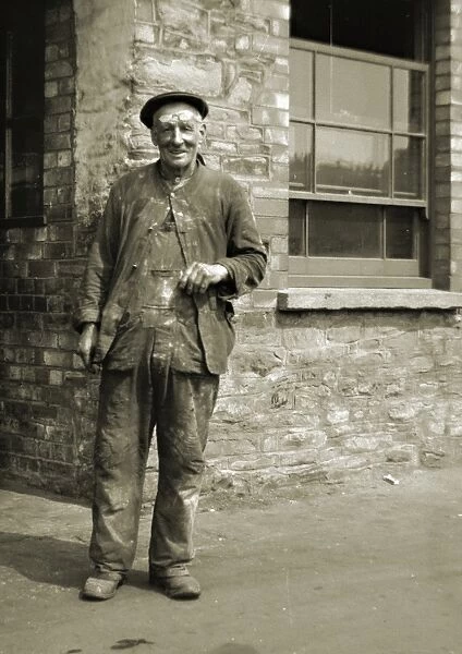 Workman standing outside a building