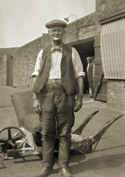 Workman standing in a yard
