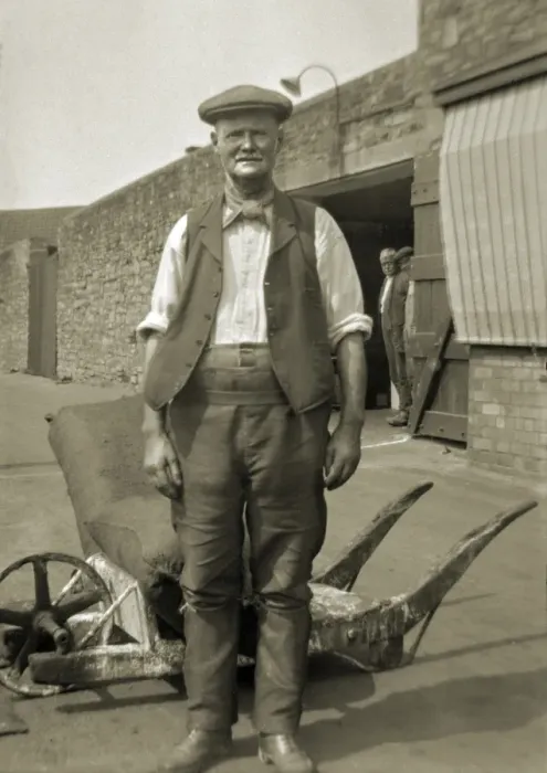 Framed Print : Workman standing in a yard Framed Print : Workman standing in a yard
