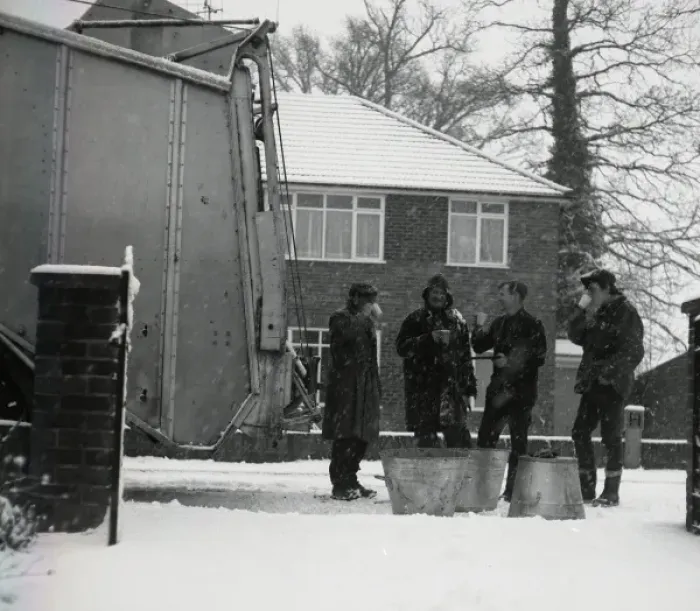 Framed Print : Four workmen stop for a cup of tea on a snowy day Framed Print : Four workmen stop for a cup of tea on a snowy day