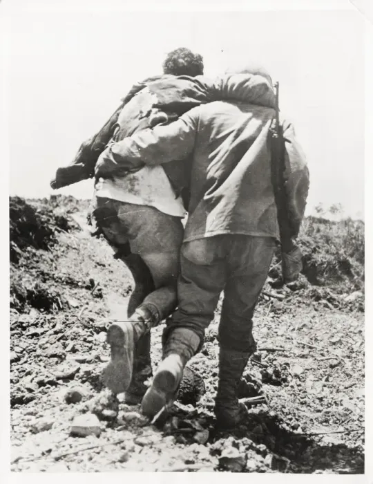 Framed Print : World War II US soldier helped towards the rear Framed Print : World War II US soldier helped towards the rear