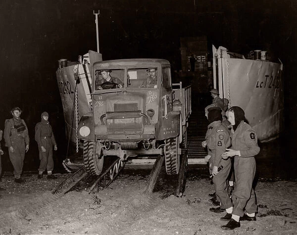 World War II WW2 - truck off a landing craft at night