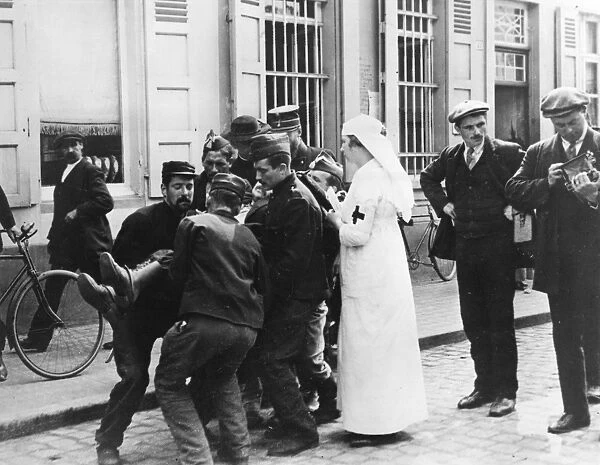 Wounded man in street, Malines, Belgium, WW1