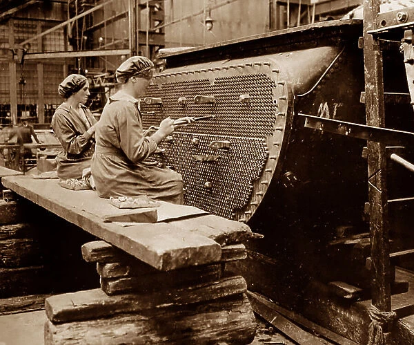 WW1 Women working on a condenser tube in a factory