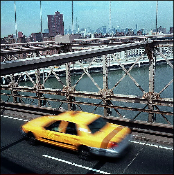 Yellow cab taxi on Brooklyn Bridge New York