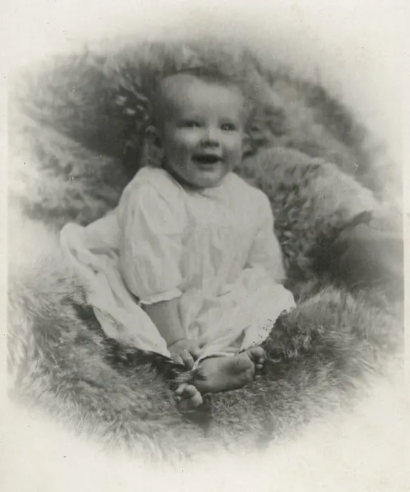 Framed Print : A young baby on a fur-covered seat Framed Print : A young baby on a fur-covered seat