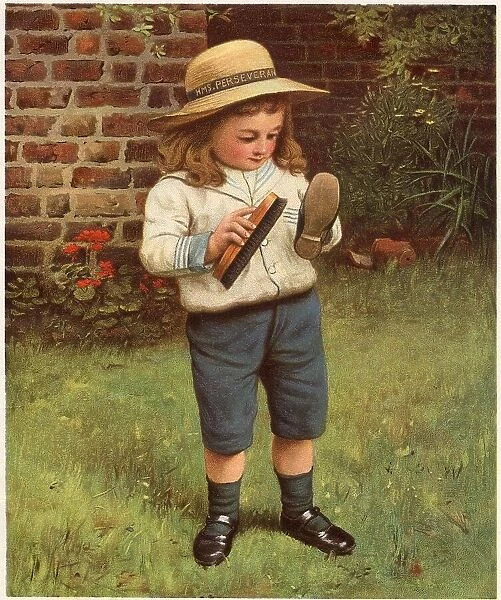 A young boy brushes his shoes. Date: 1910