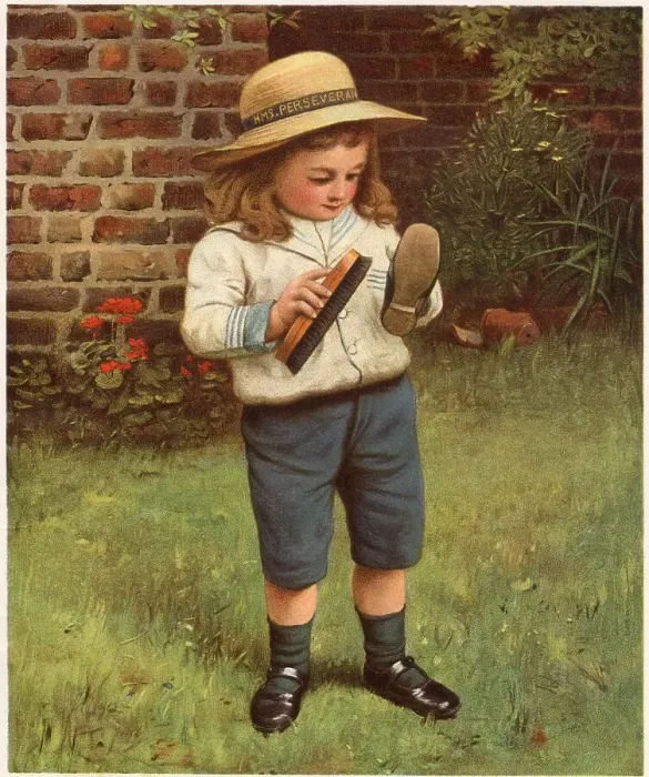 Framed Print : A young boy brushes his shoes. Date: 1910 Framed Print : A young boy brushes his shoes. Date: 1910