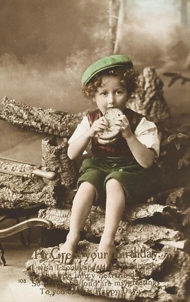 Young boy eating a large sandwich