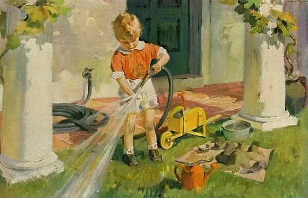 Young boy with garden hose