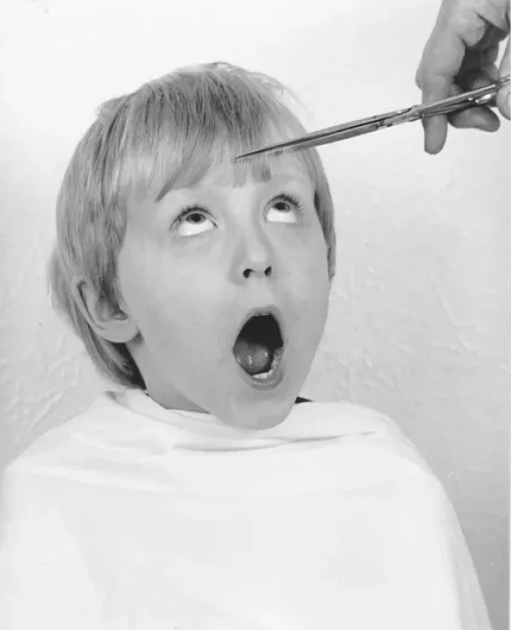 Framed Print : Young boy having a haircut Framed Print : Young boy having a haircut