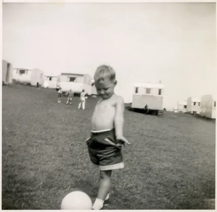 Framed Print : Young boy plays with a football at a holiday camp Framed Print : Young boy plays with a football at a holiday camp