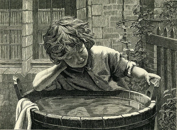 Young boy at a wash tub