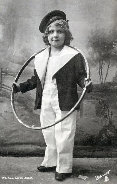 Young child posing in a sailors outfit holding a hoop - A Little Jack Tar - We All Love