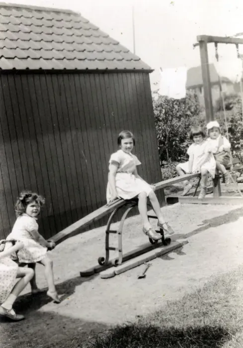 Framed Print : Four young children playing on a see-saw Framed Print : Four young children playing on a see-saw