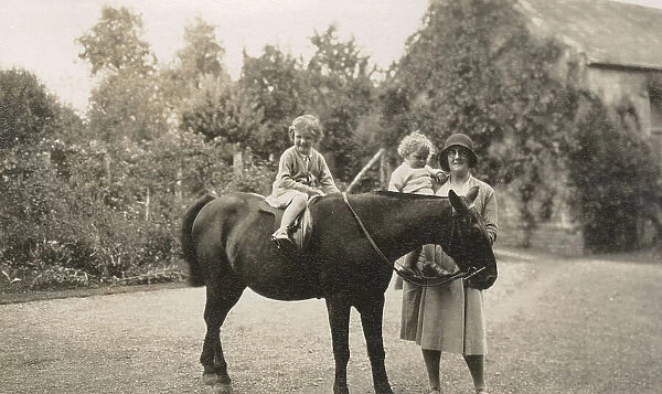 Two young children, a pony and their nurse - Oddington House