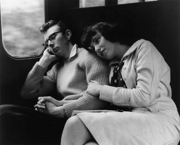 Young couple relaxing in a train compartment