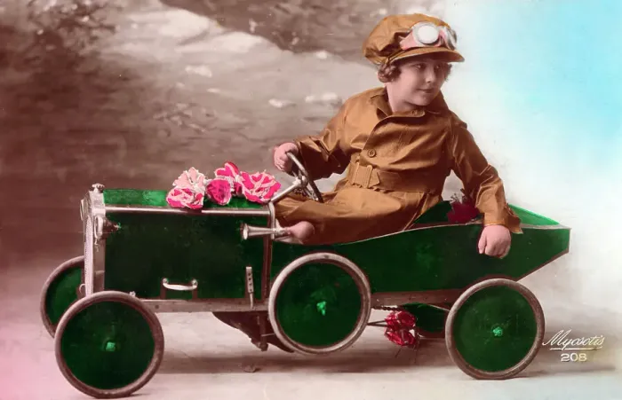 Framed Print : Young French girl driving her green pedal car Framed Print : Young French girl driving her green pedal car