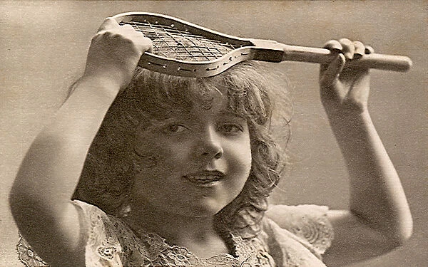 Young girl holding very little tennis racquet Date: 1905