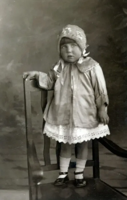 Framed Print : Young girl posing for studio photograph standing on a chair Framed Print : Young girl posing for studio photograph standing on a chair