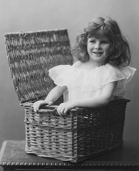 Young girl in wicker basket