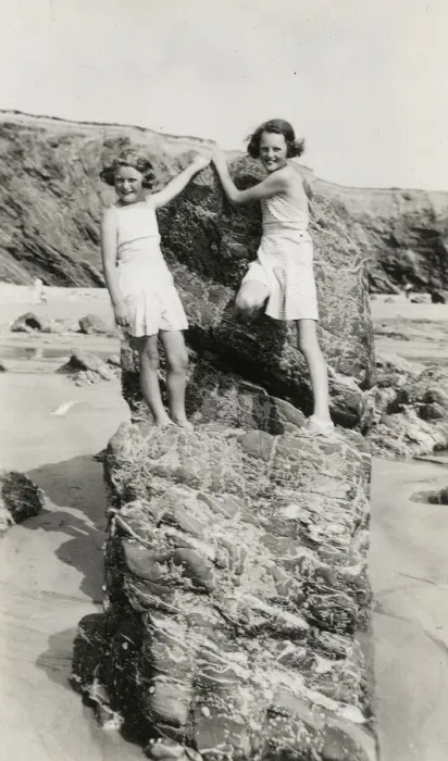 Framed Print : Two young girls playing on the rocks on a Cornish beach Framed Print : Two young girls playing on the rocks on a Cornish beach