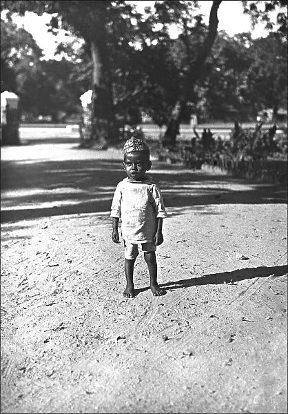 A young Indian toddler on a dusty road