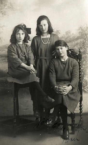 Three young ladies pose for a formal studio portrait