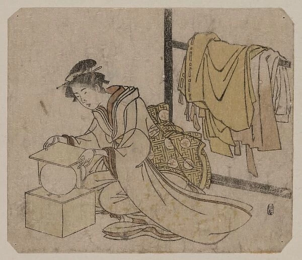 Young lady removing a kemari (ball) from its box