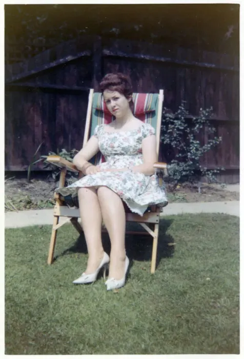 Framed Print : A young lady sat in a neat garden in a canvas-backed chair Framed Print : A young lady sat in a neat garden in a canvas-backed chair