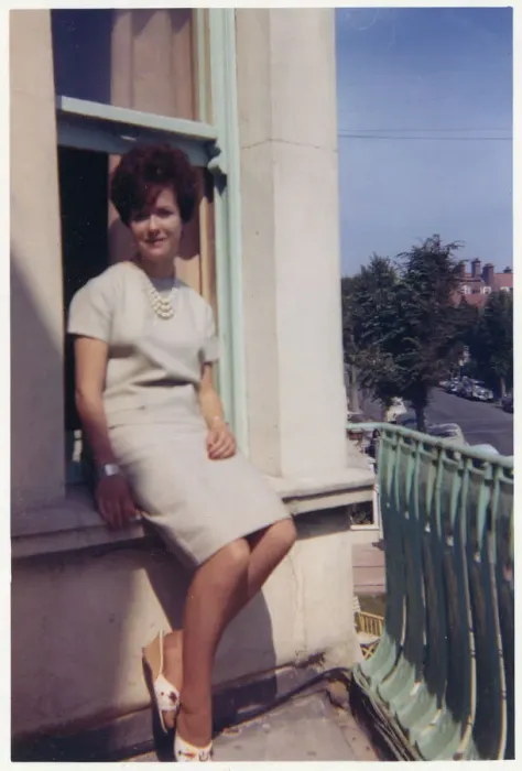 Framed Print : Young lady seated on exterior window ledge - seaside hotel Framed Print : Young lady seated on exterior window ledge - seaside hotel