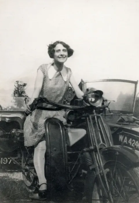 Framed Print : Young lady seated on a Motorbike (with sidecar) Date: circa 1930s Framed Print : Young lady seated on a Motorbike (with sidecar) Date: circa 1930s