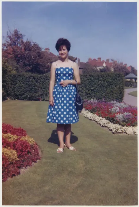 Framed Print : Young lady standing between beautifully-manicured flowerbeds Framed Print : Young lady standing between beautifully-manicured flowerbeds