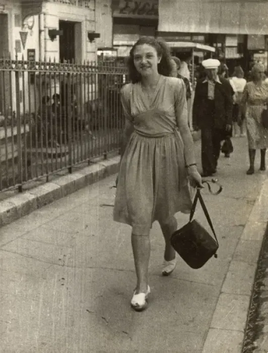 Framed Print : Young lady strolling confidently along, swinging her handbag Framed Print : Young lady strolling confidently along, swinging her handbag