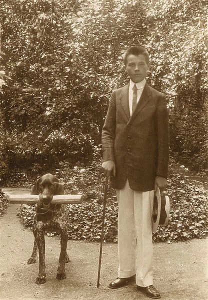 Young man with a dog in a garden
