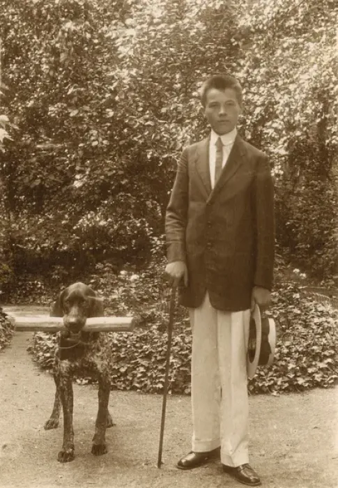 Framed Print : Young man with a dog in a garden Framed Print : Young man with a dog in a garden