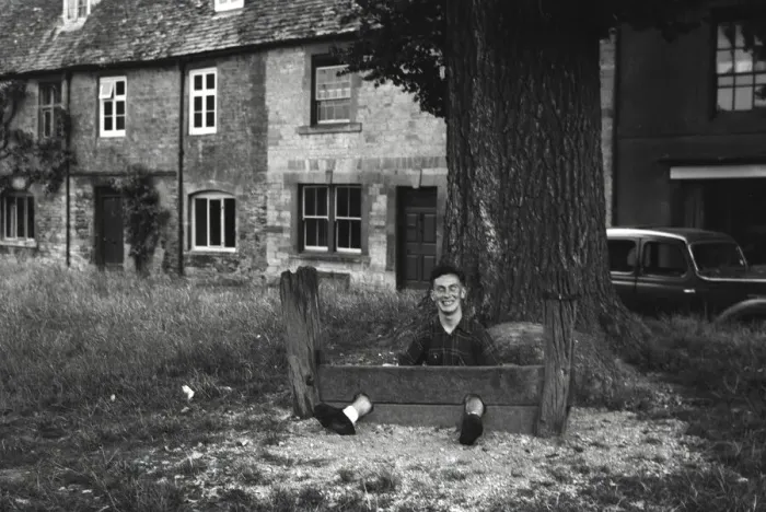 Framed Print : Young man fooling about in The Stocks Framed Print : Young man fooling about in The Stocks