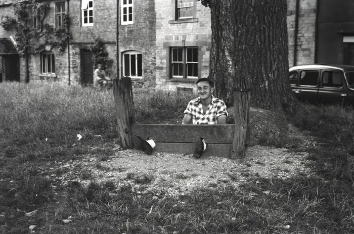 Framed Print : Young man fools about in The Stocks Framed Print : Young man fools about in The Stocks