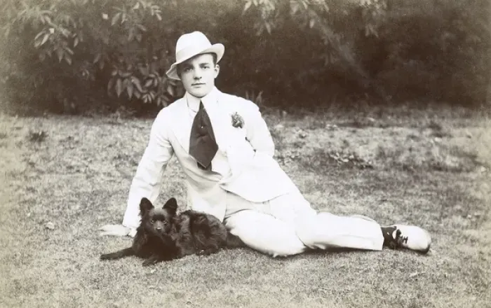 Framed Print : Young man in garden with small dog Framed Print : Young man in garden with small dog